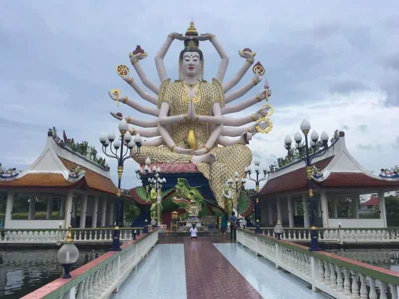 Visitors praying before the towering Guanyin statue at Wat Plai Laem Koh Samui