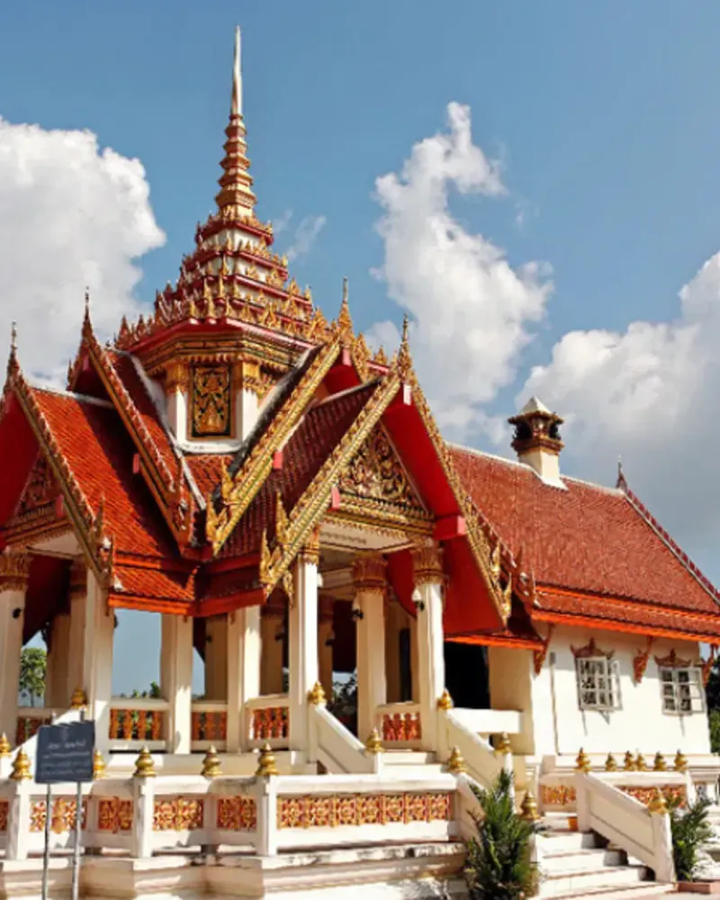 Golden temple hall roofline with layered eaves under a blue sky