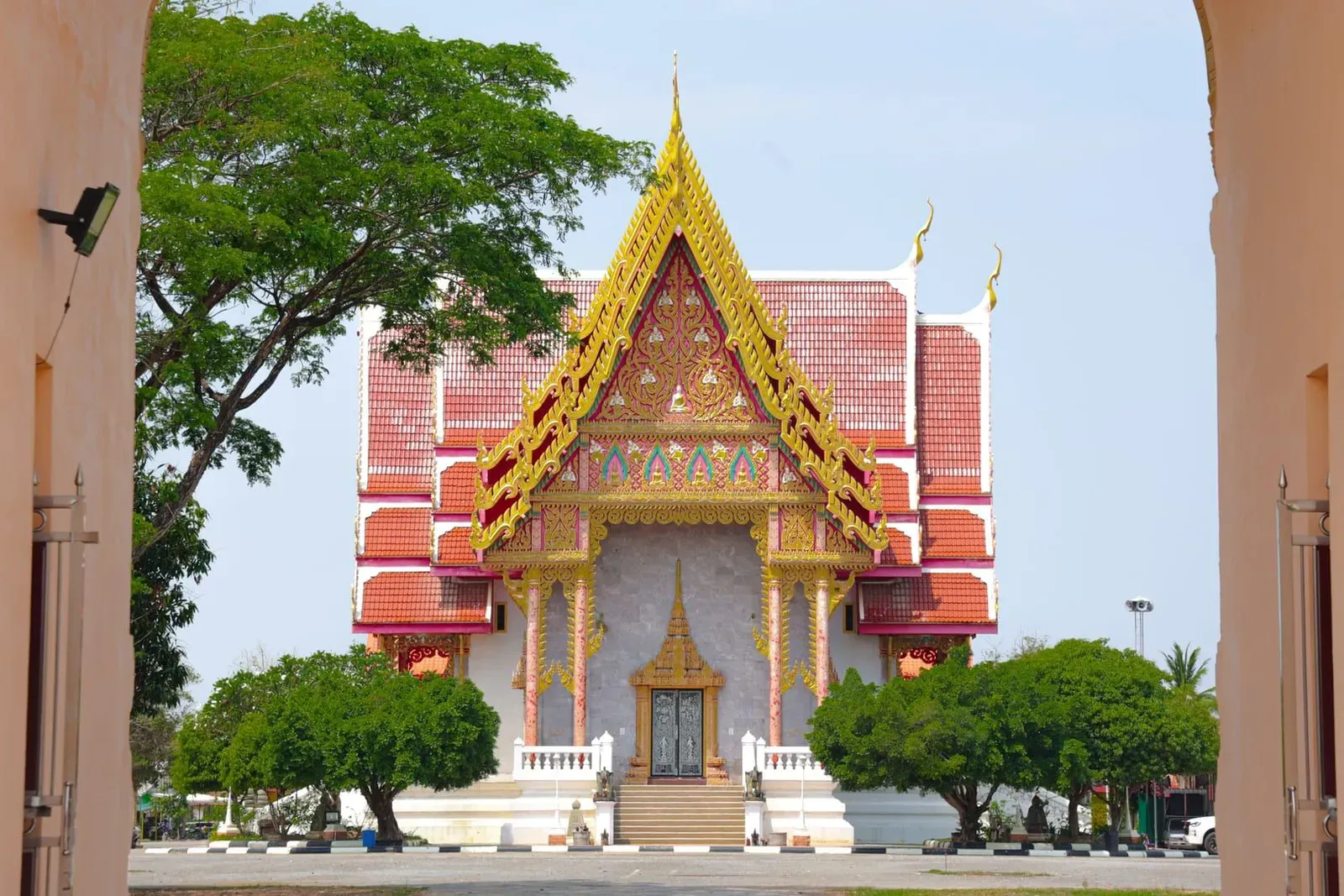 Ornate red and gold relief carvings on the exterior wall of Wat Sila Ngu temple on Koh Samui