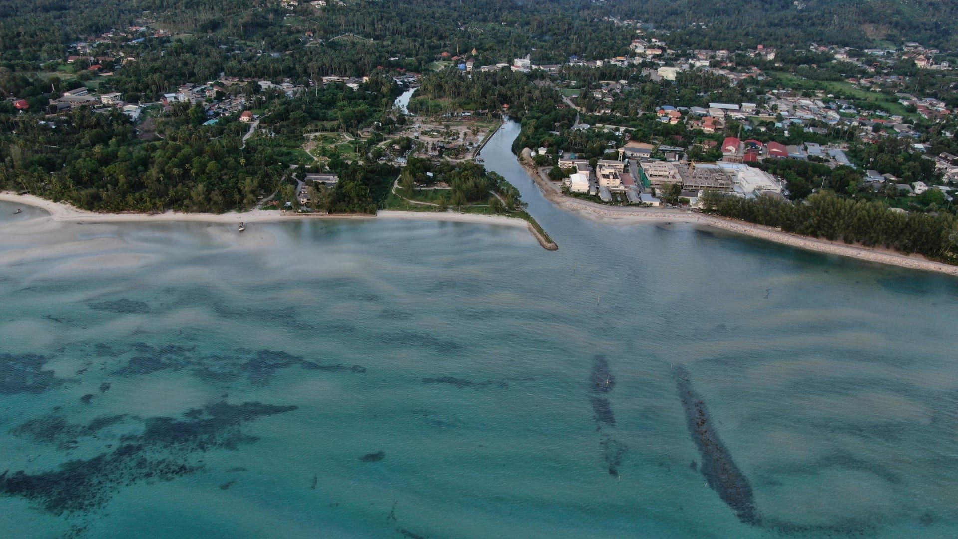 Aerial view of Koh Samui coastline with turquoise water and tropical greenery