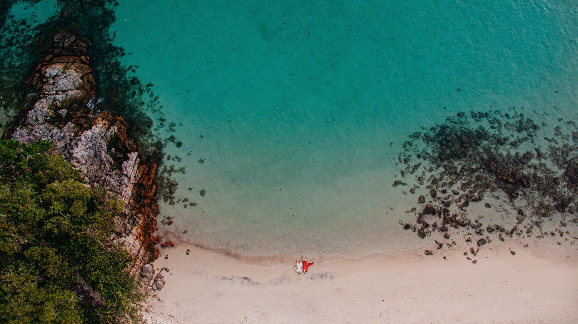 Turquoise water and coral reef visible from above at a Koh Samui granite boulder beach