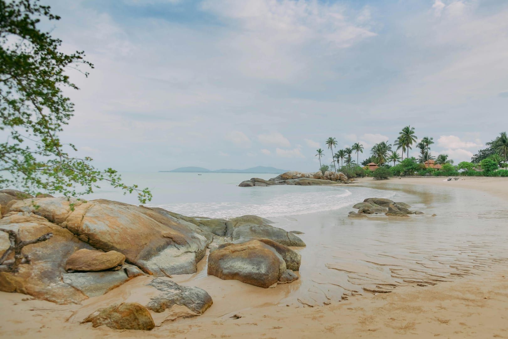 Pristine beach with palm trees and rocks at best beaches Koh Samui