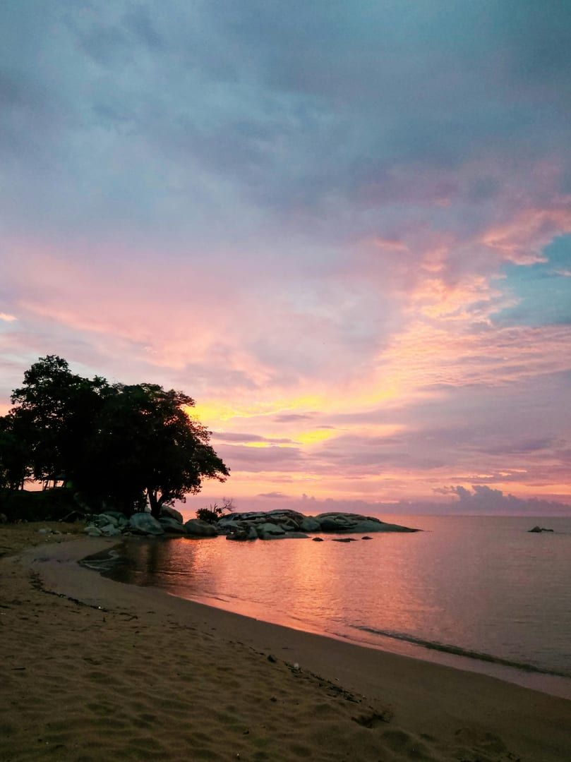 Twilight beach scene with vibrant sky reflecting on shallow water Lipa Noi