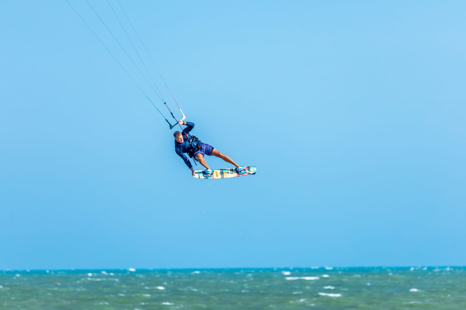 Kiteboarder performing an aerial trick above the Gulf of Thailand near Hua Thanon village
