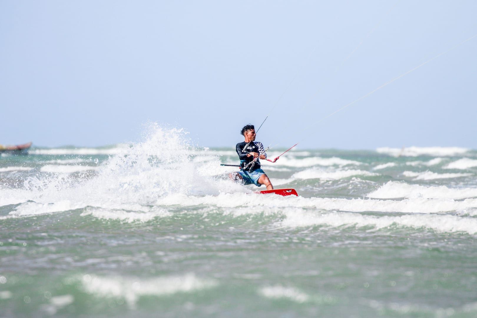 Kitesurfer riding across calm waters near Hua Thanon village on Koh Samui's south coast