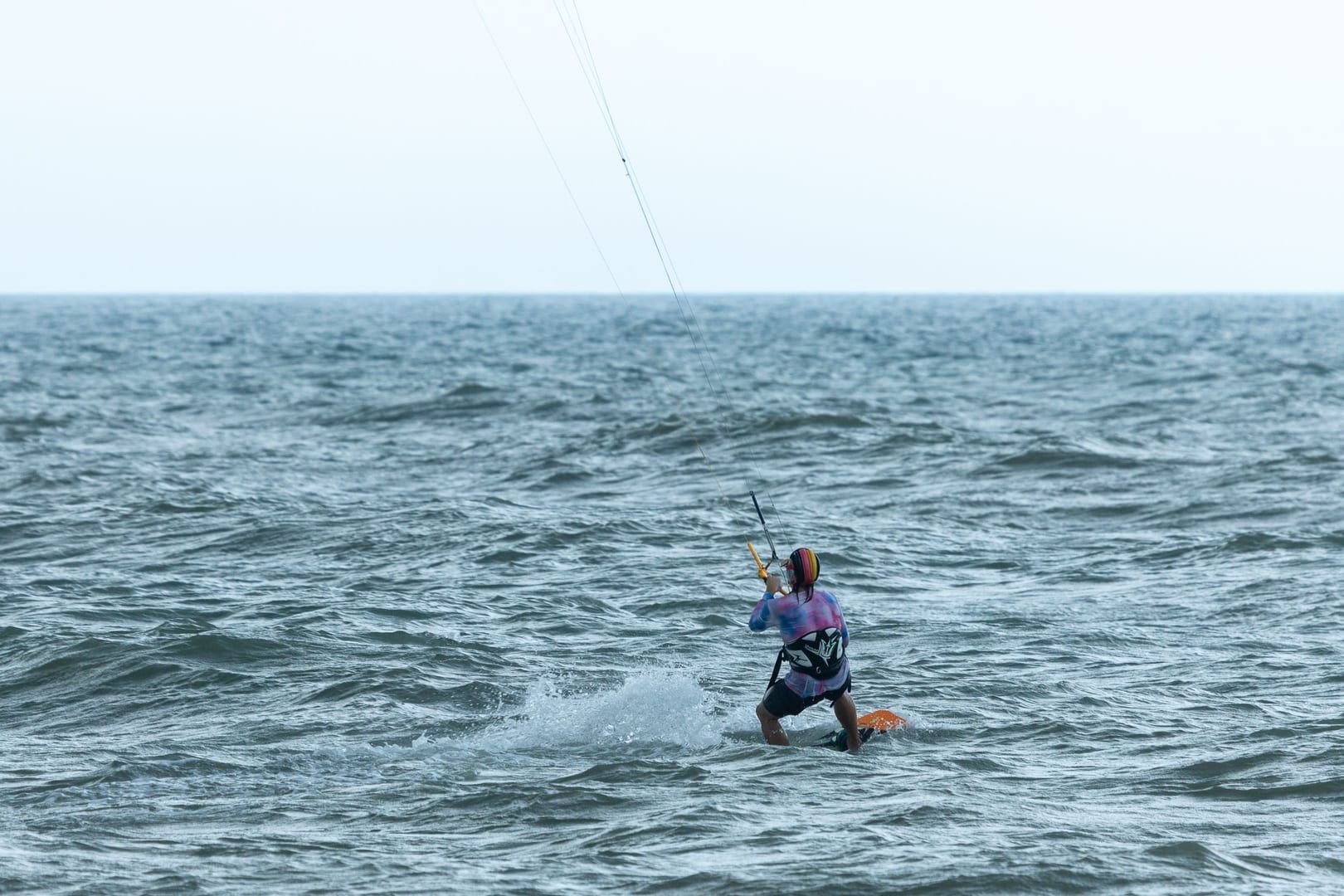 Kitesurfer riding the wind on a quiet secluded beach on Koh Samui's south coast