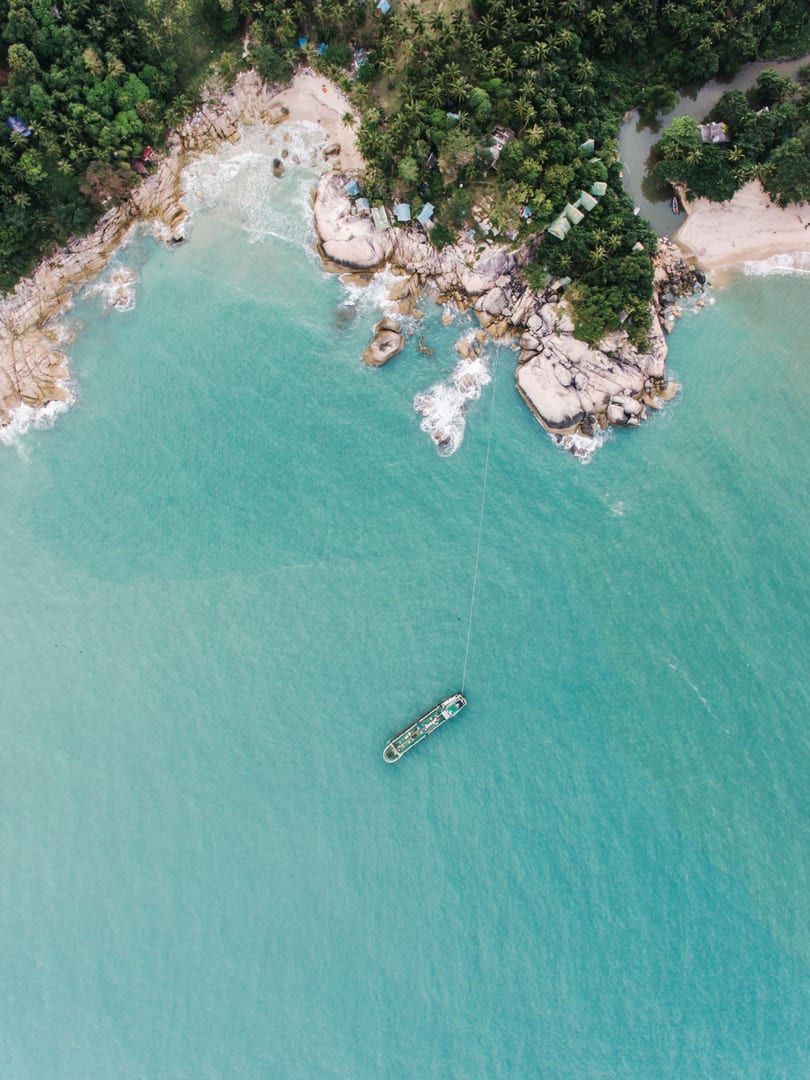 Aerial photograph of a rocky shoreline and turquoise water near Cape Plai Laem Koh Samui