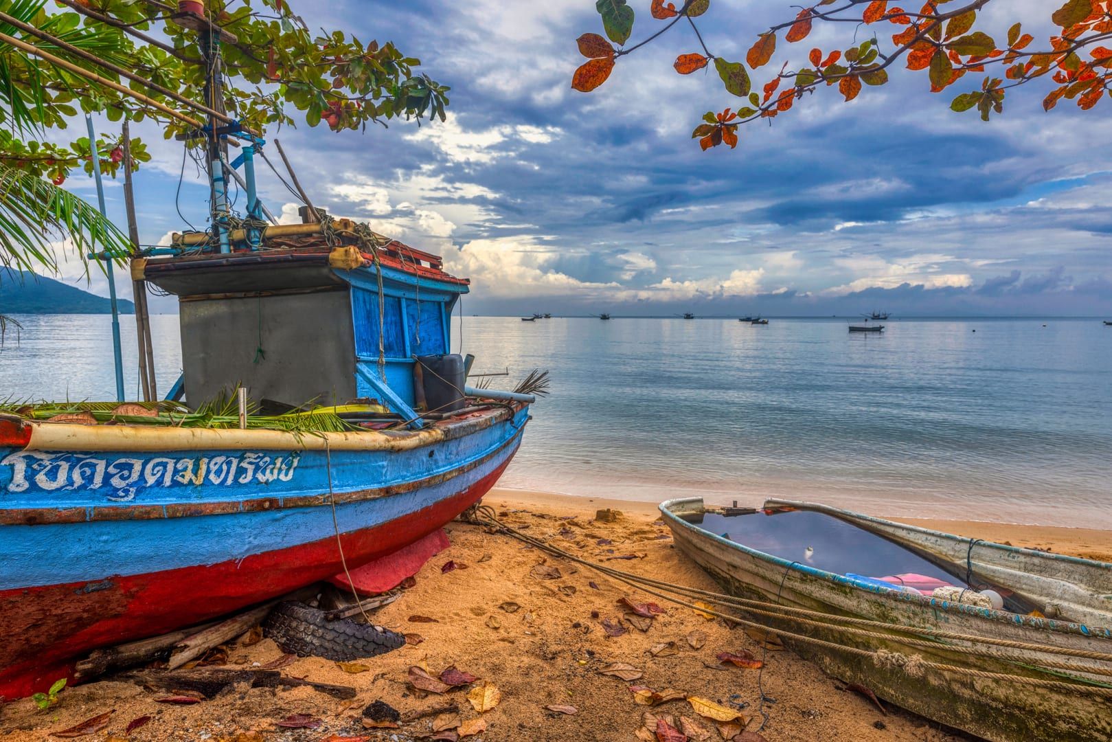Colorful traditional fishing boats moored on the shore near Thong Krut village Koh Samui