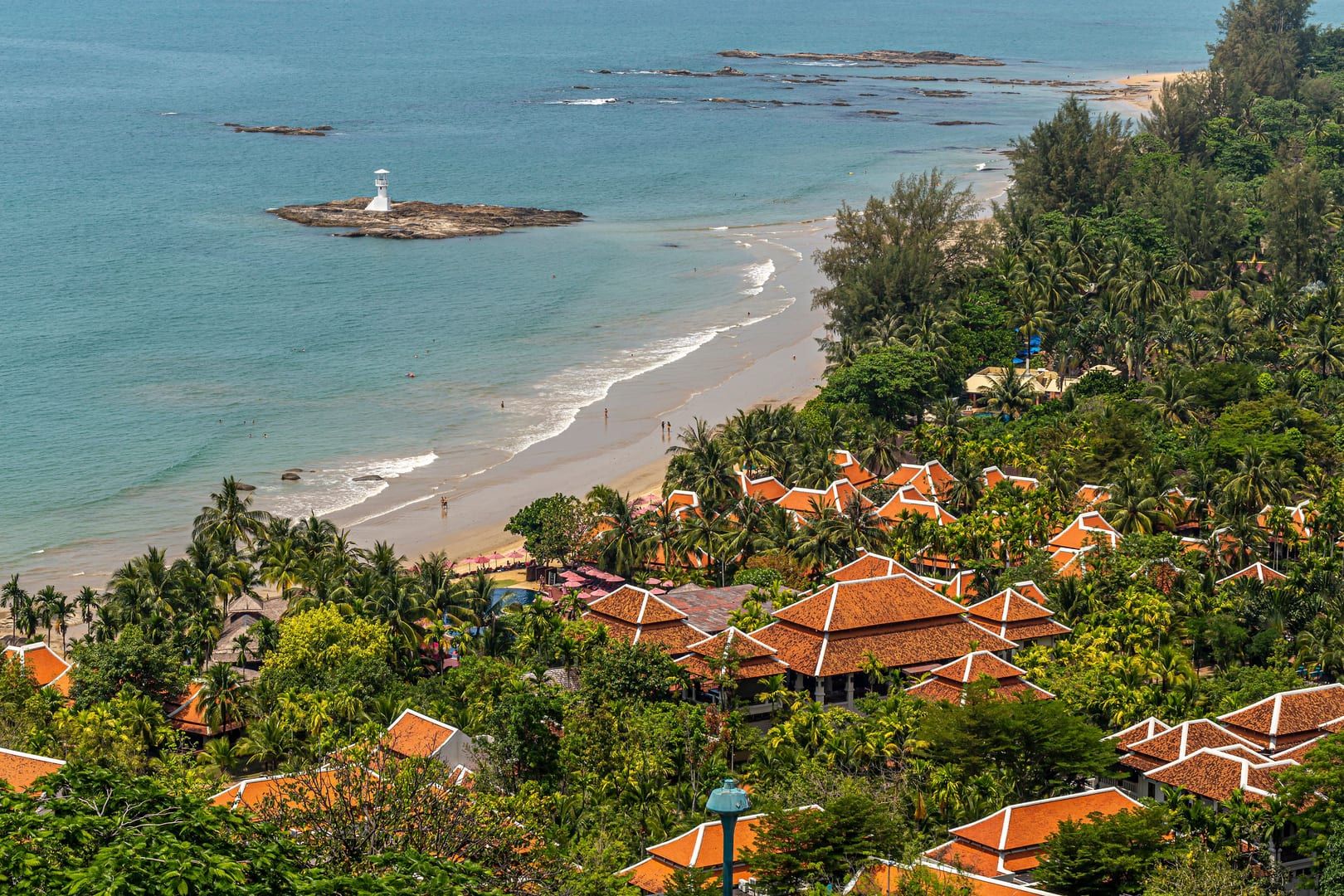 Aerial view of a small coastal village with palm trees near Koh Samui's northwest beaches