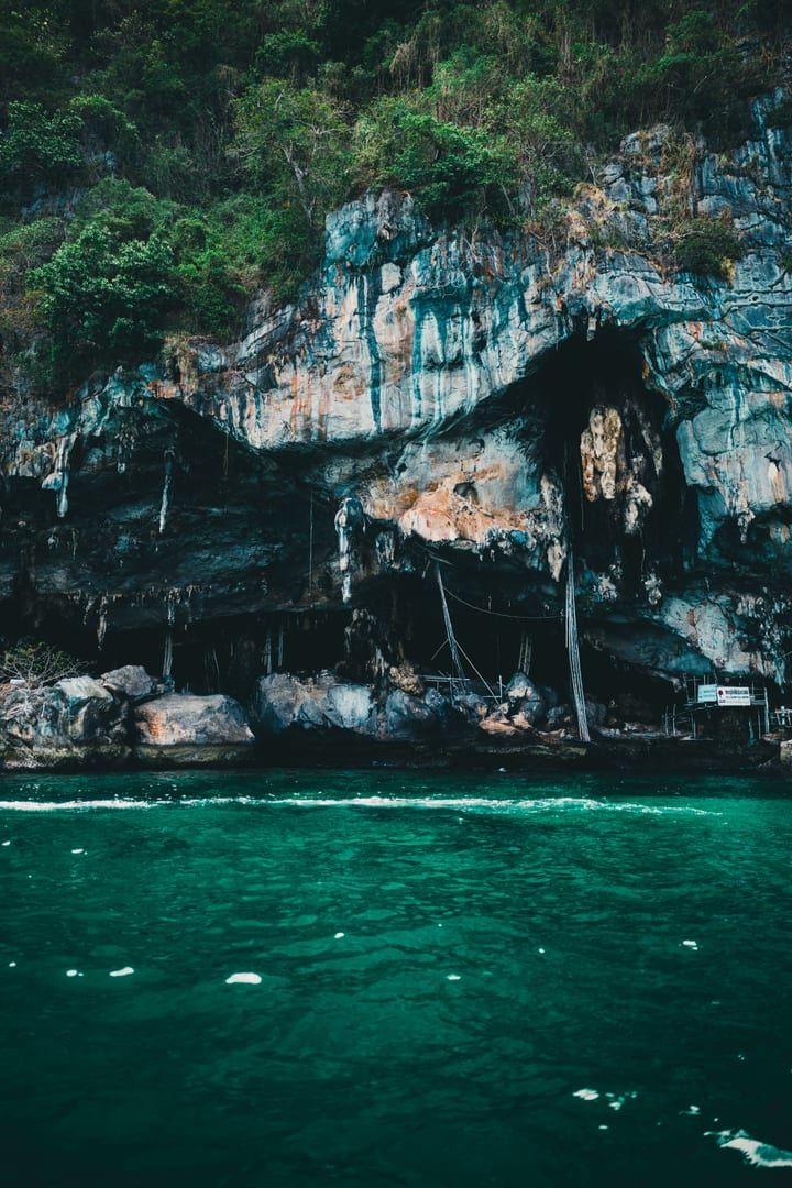 Steep limestone cliffs rising above emerald water in Ang Thong National Marine Park