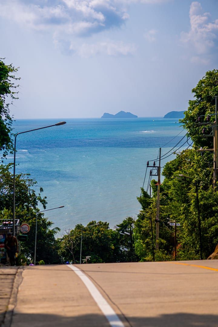 Scenic hilltop road view of Koh Samui's tropical coastline near Lamai Viewpoint