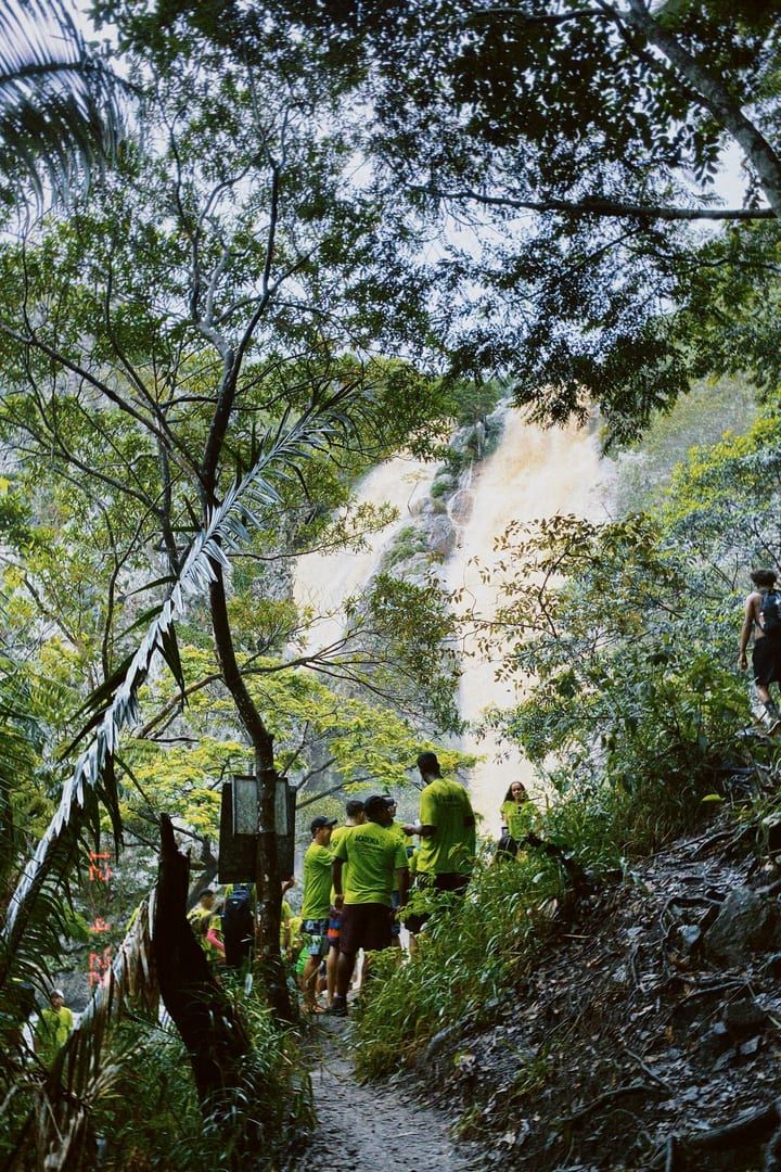 People hiking through mountain jungle forest on Koh Samui waterfall trek