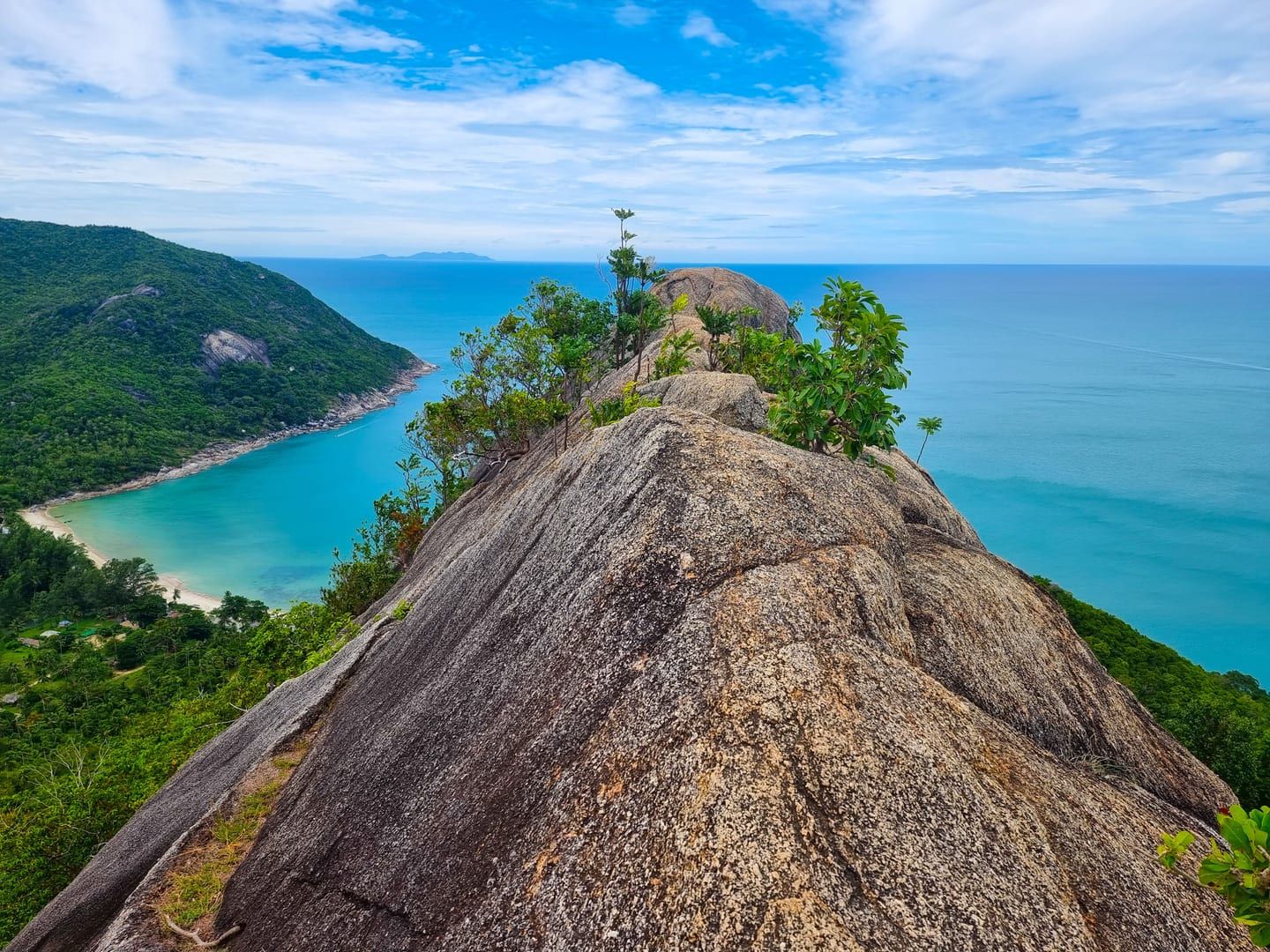 Rocky headland and swimming cove backed by jungle hills close to Overlap Stone Koh Samui