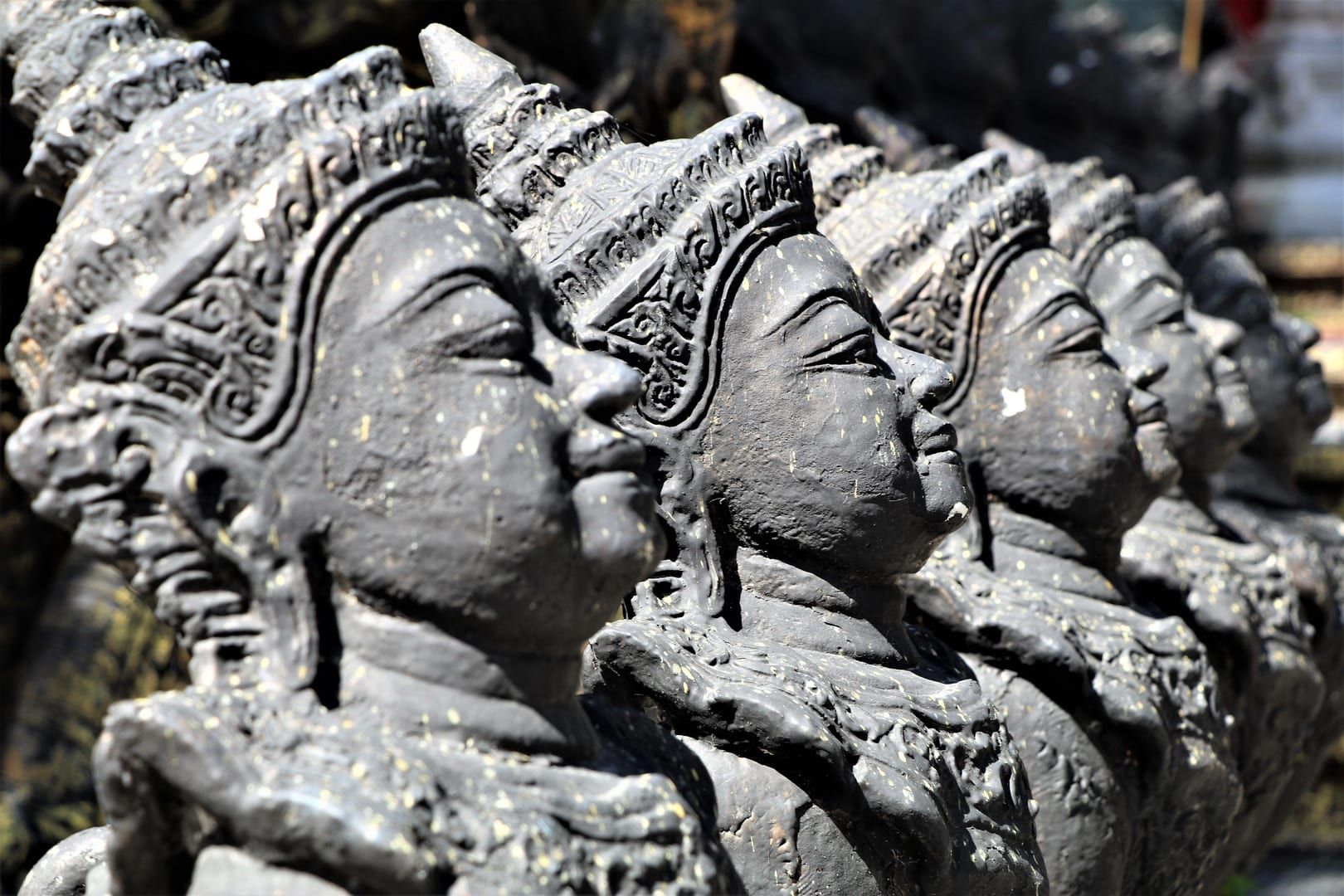 Row of carved stone deity statues along the Secret Buddha Garden Trail Koh Samui