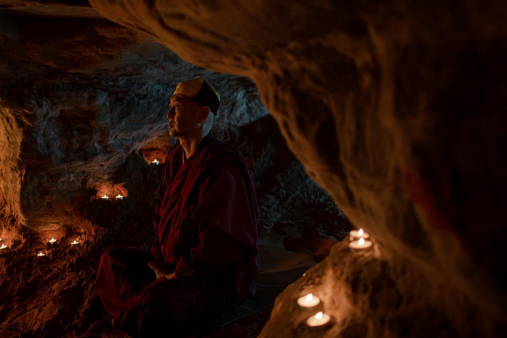 Stone altar and candles inside Tham Phra cave