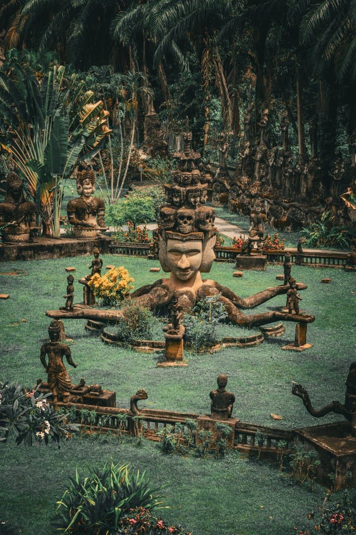 Moss-covered stone carvings at Samui's Magic Garden