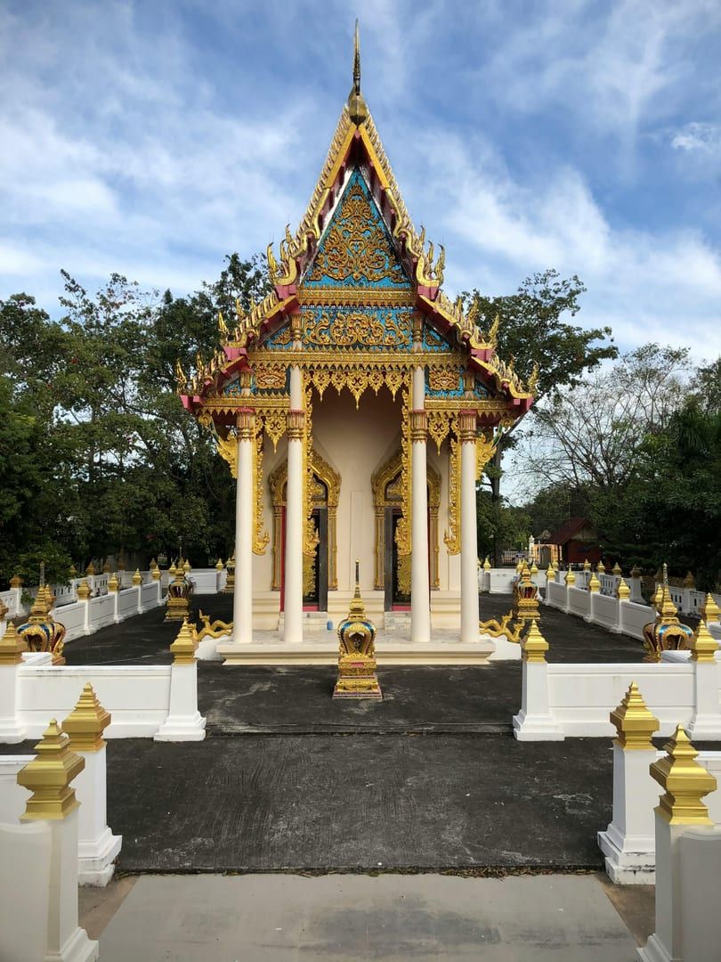 Offering area with candles and incense at the glass shrine