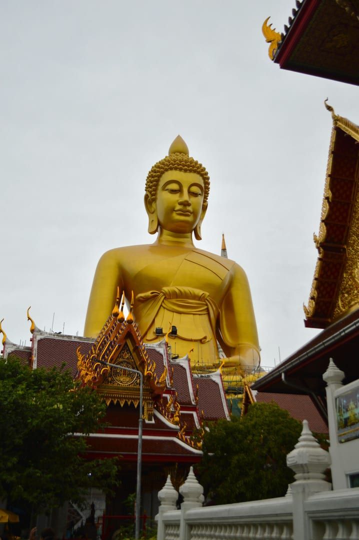 Majestic golden Big Buddha statue rising above temple roofs in Koh Samui