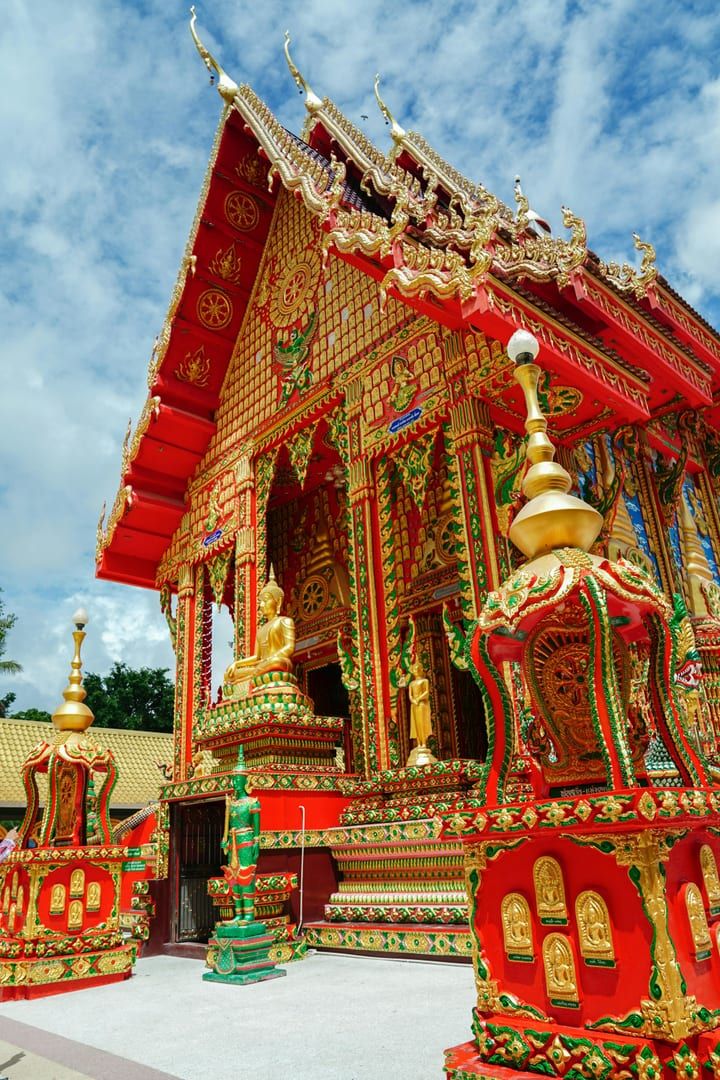 Vibrant gold and red Thai Buddhist temple architecture at Wat Plai Laem Koh Samui