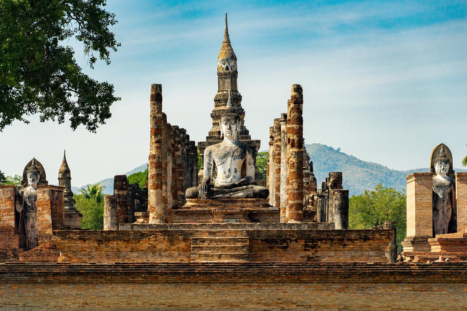Ancient Buddha statue at ruins of historic Thai temple similar to Wat Pradoem Koh Samui