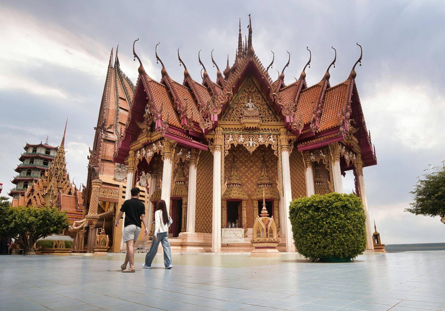 Detailed carvings on the red walls of Wat Sila Ngu Samui