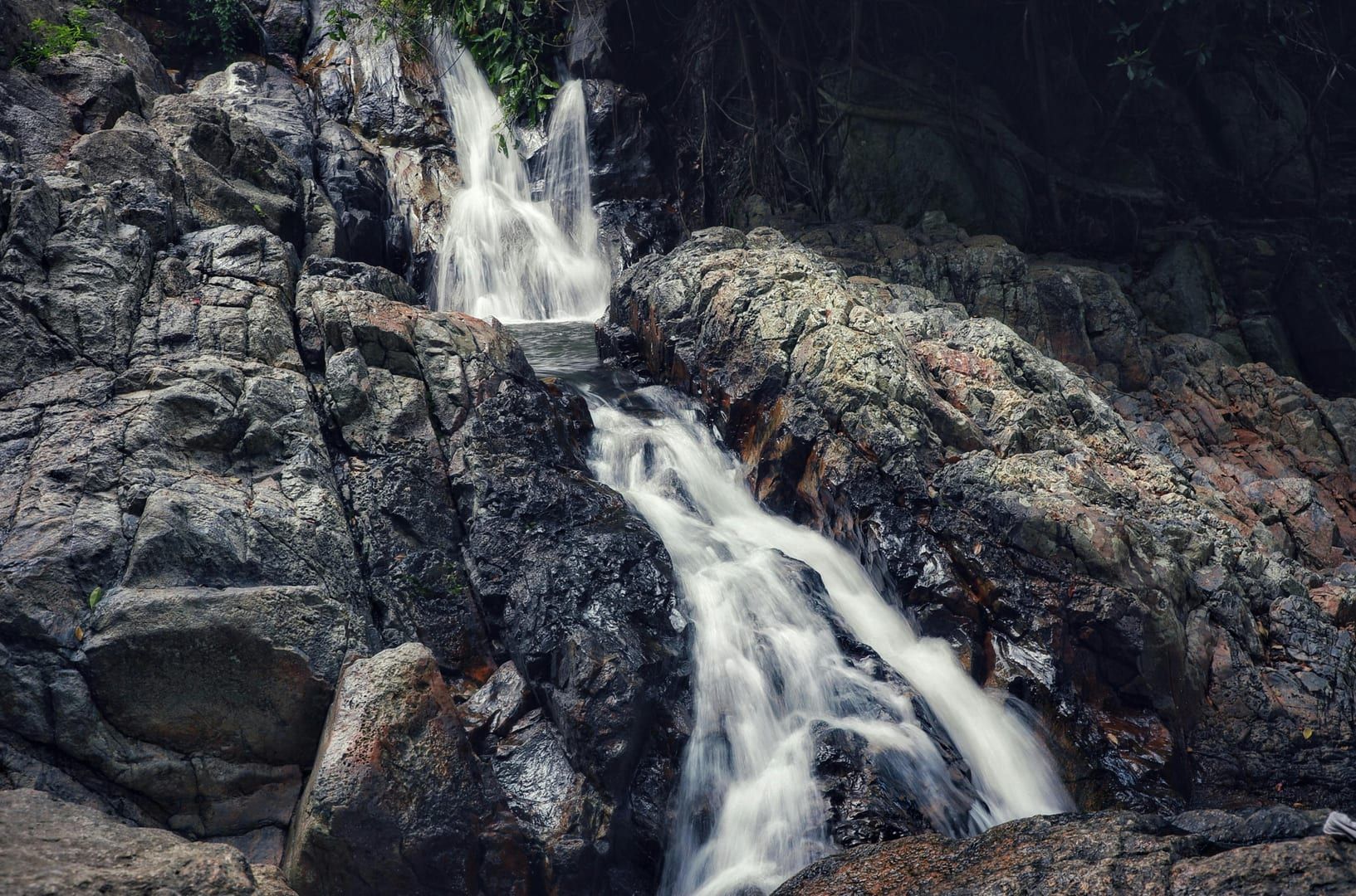 Na Muang Waterfall cascading over rocky formations on Koh Samui
