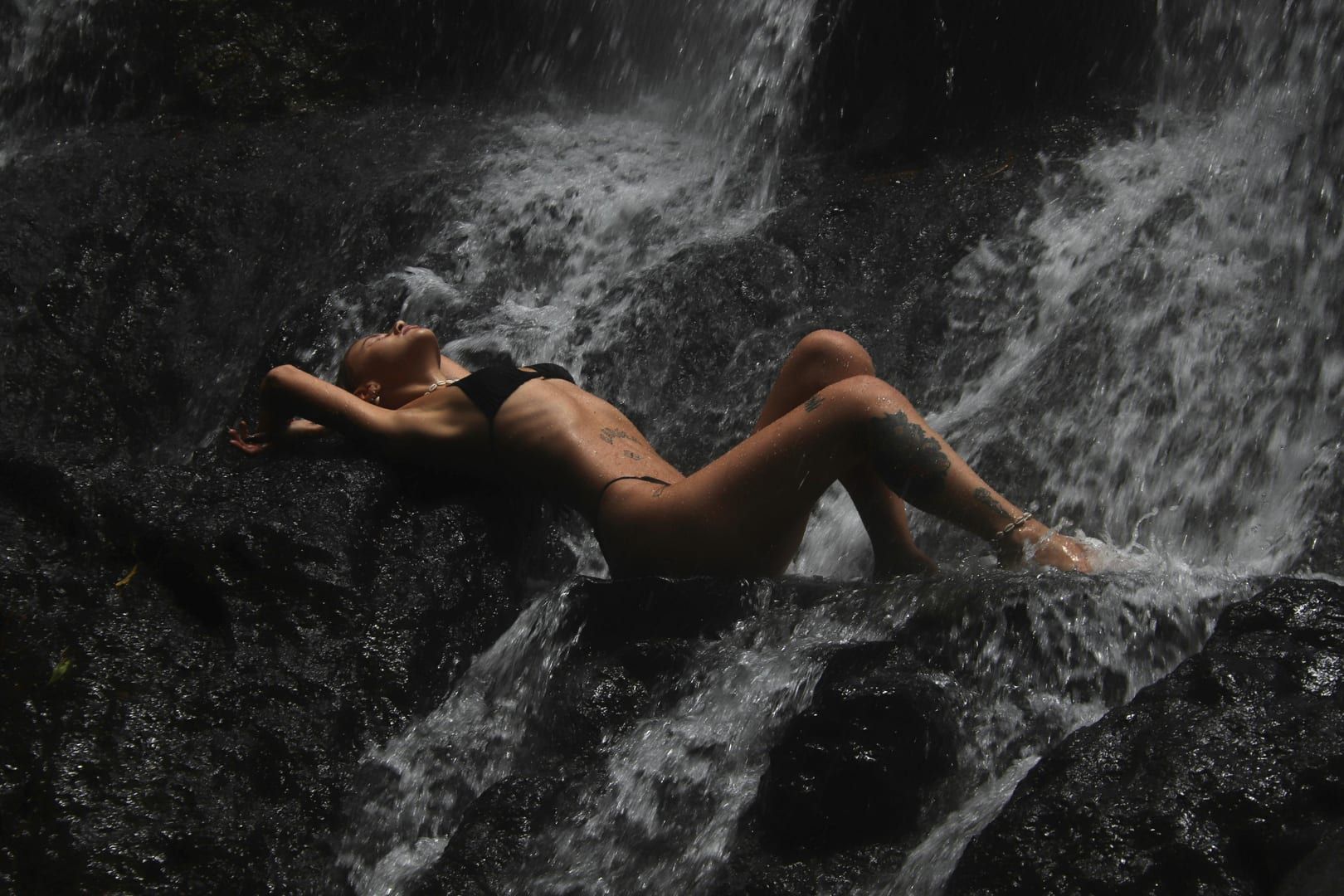 Tropical vegetation and palm trees near the waterfall